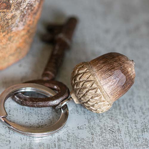 Keychain with acorn design on a textured surface