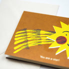 greetings card with a yellow sun illustration on a white background