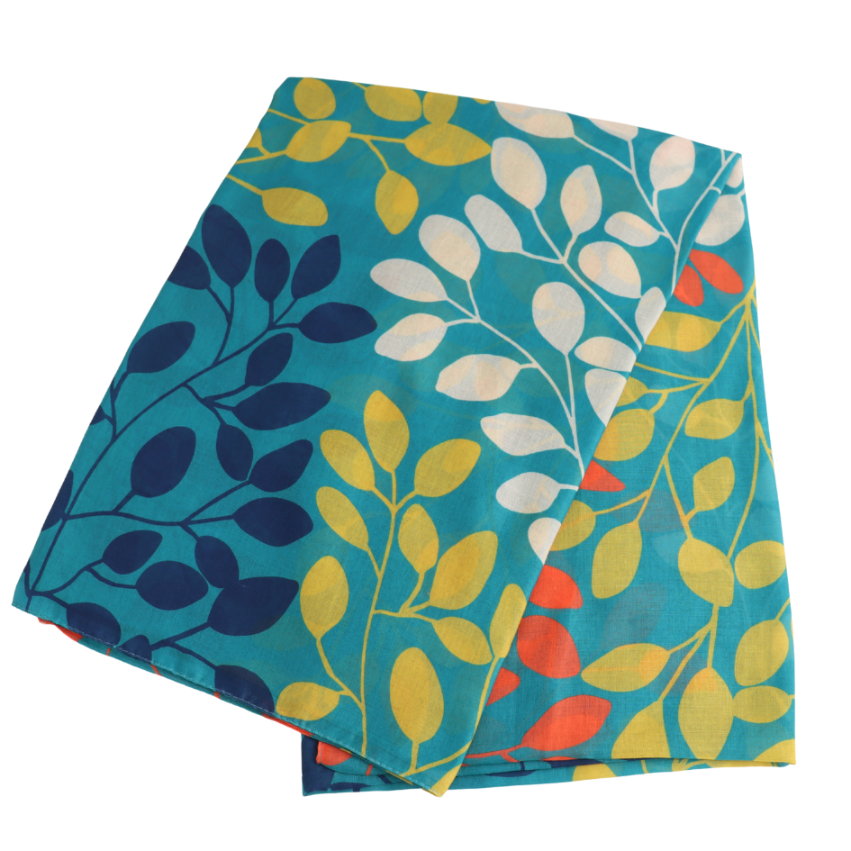 A folded square textile, likely a scarf or pocket square, featuring a botanical leaf pattern in teal, navy, yellow, white, and coral red on a white background.