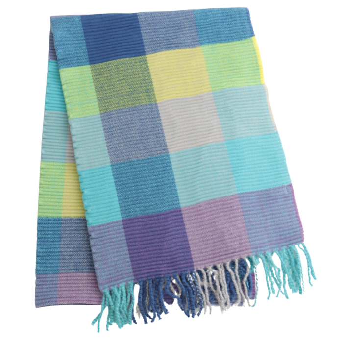 A folded woven scarf with a plaid pattern in shades of blue, teal, yellow, purple, and gray, finished with fringed edges, shown on a plain white background.