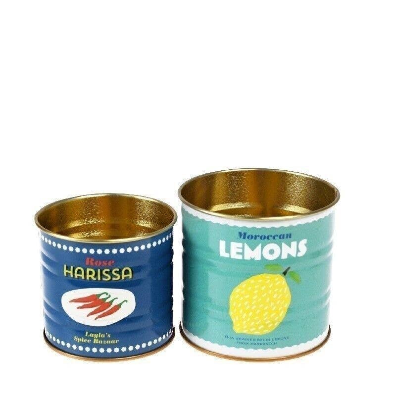 Two metal cans, one labeled 'Rose Harissa' and the other 'Moroccan Lemons', on a white background.