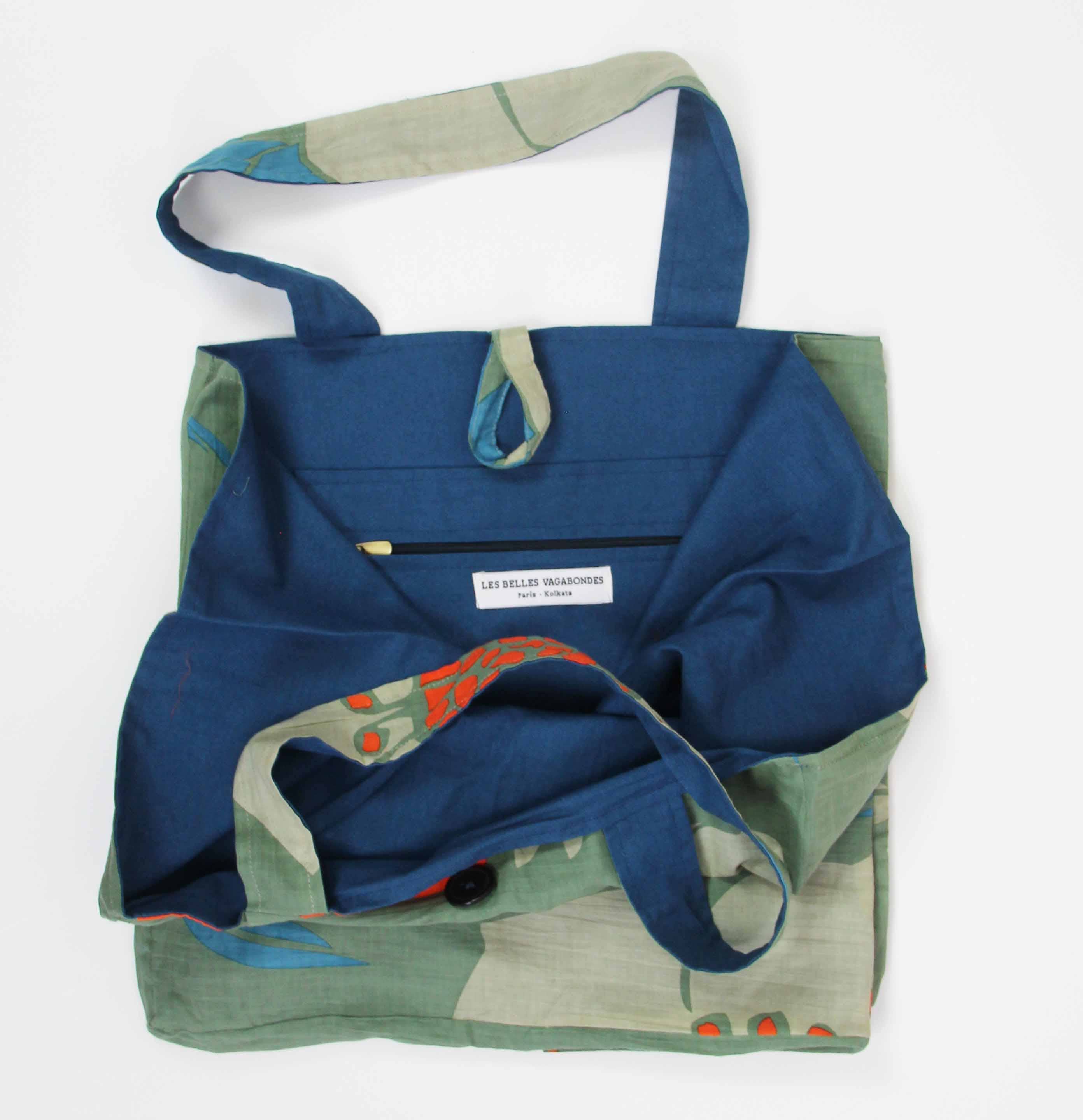 Blue and green tote bag with floral patterns on a white background