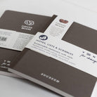 Sustainable stationery notebooks with visible branding on a white background