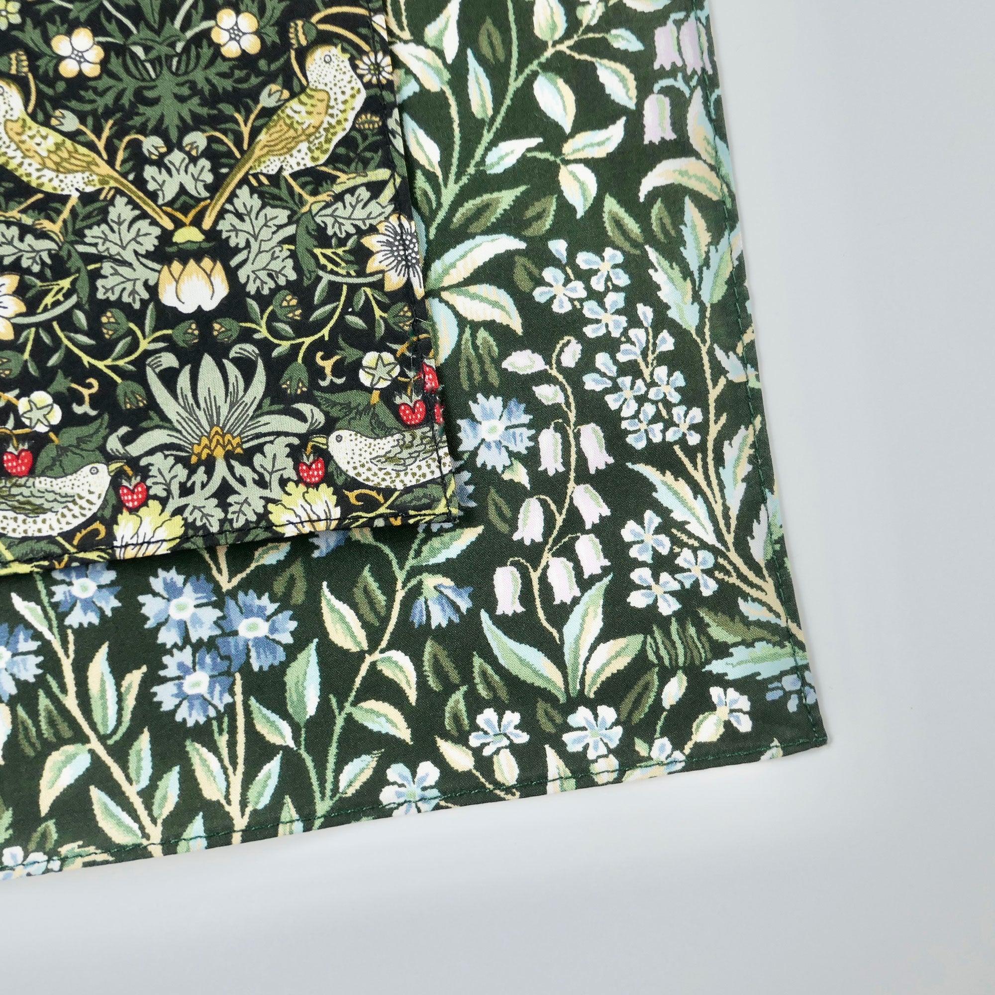 Floral and bird patterned fabric on a white background