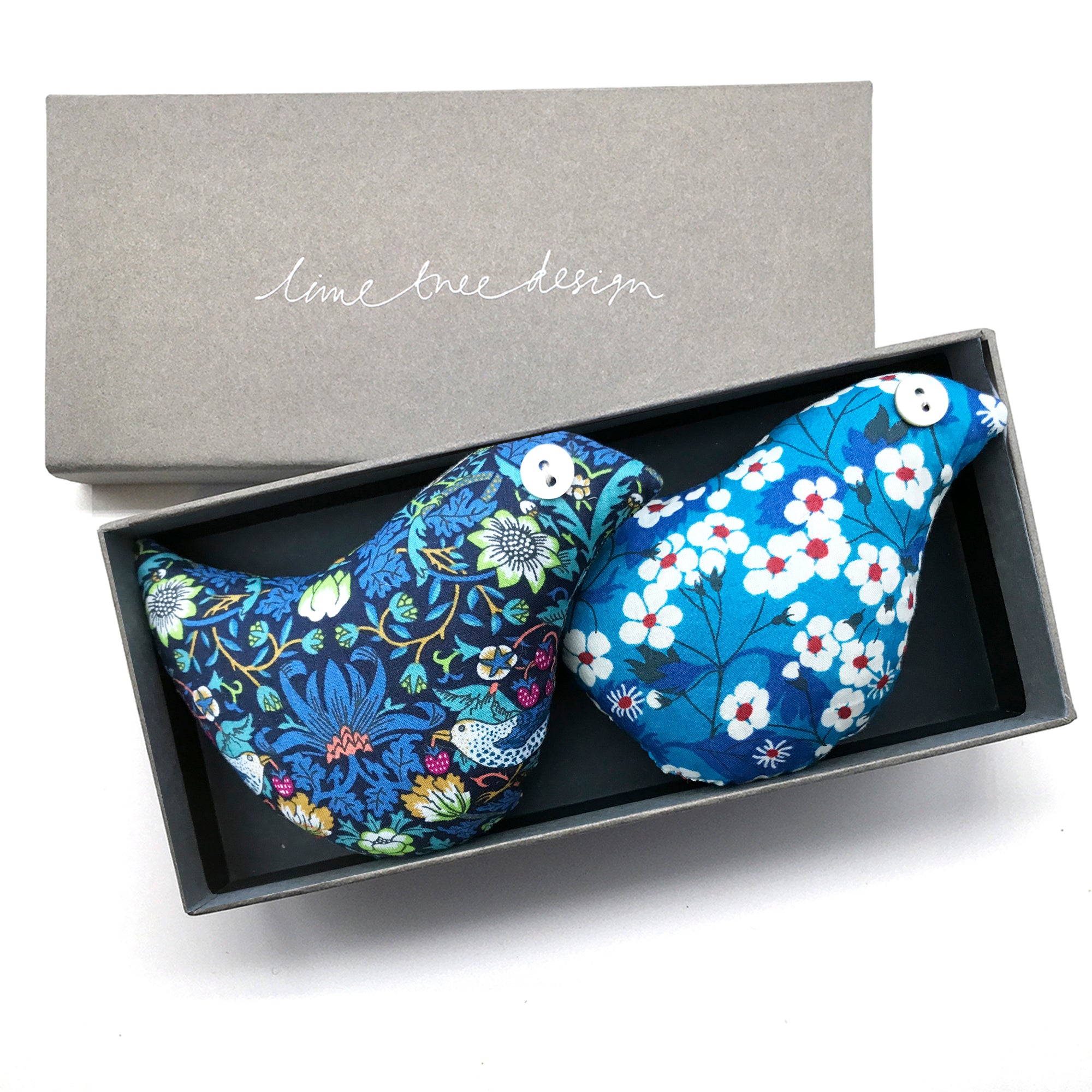 Floral-patterned bird-shaped lavender pillows in a box with 'lime tree design' branding.
