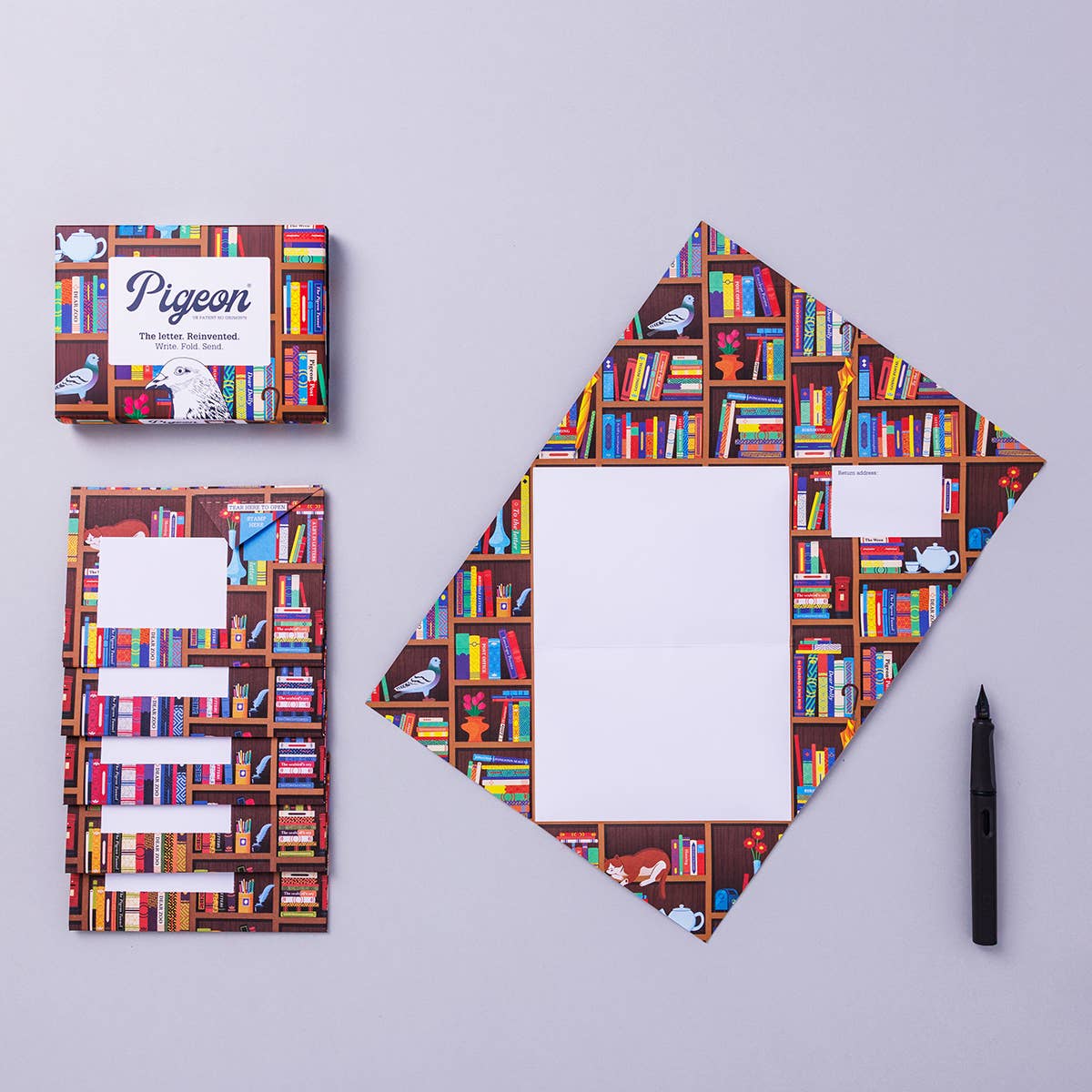 Letter set with bookshelf design on cover and spine, pen on grey background