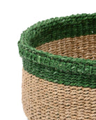 Close-up of a woven basket with green top and brown bottom on a white background