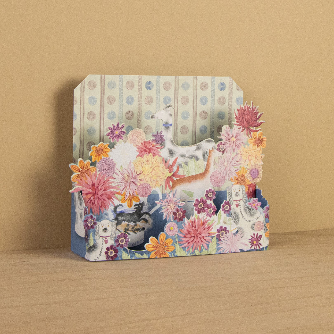 Decorative card with floral and animal designs on a wooden surface and beige background