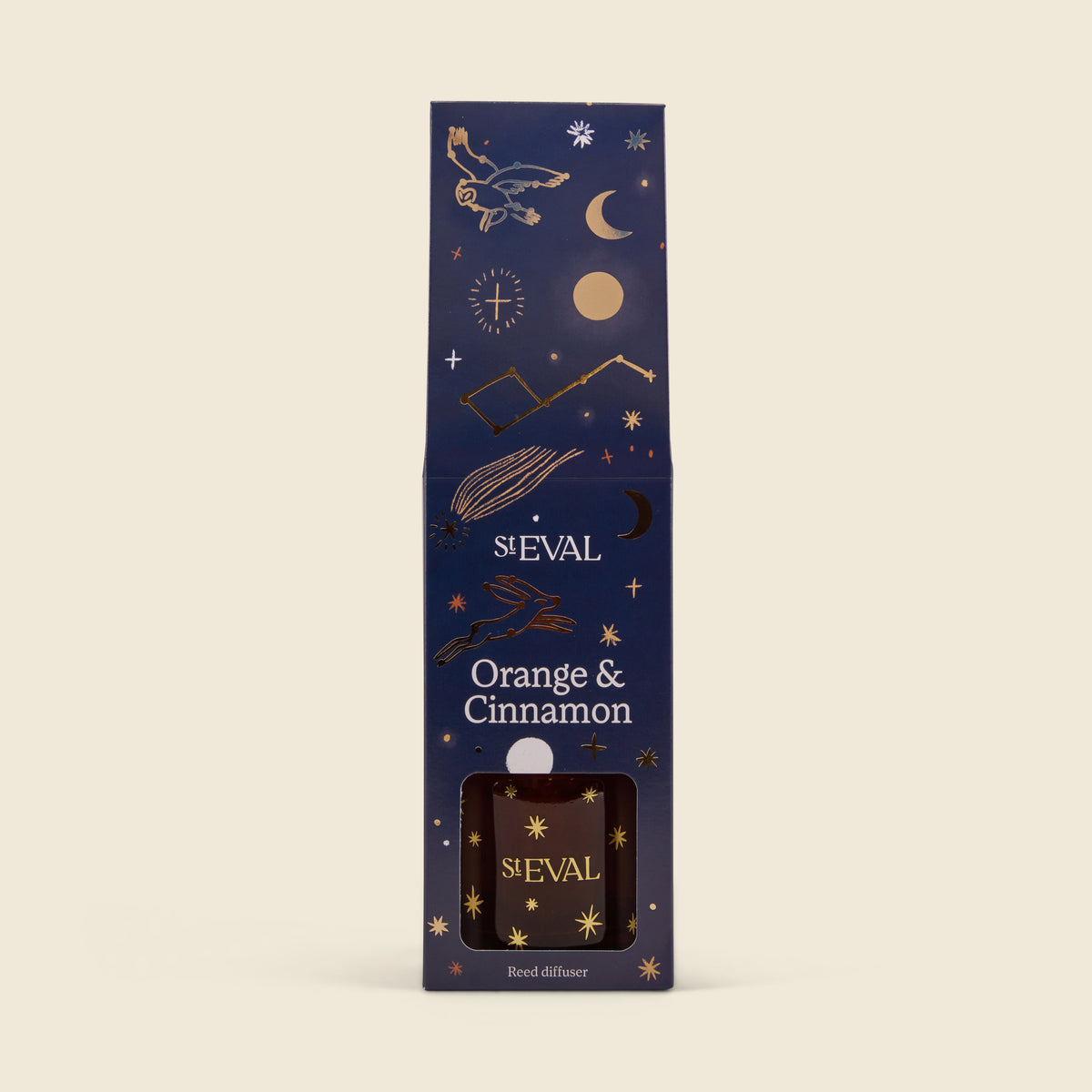 S'Eval Orange & Cinnamon reed diffuser in its dark navy blue packaging box, decorated with gold celestial illustrations like a crescent moon, stars, and a compass.