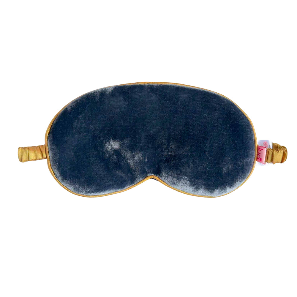 Blue velvet eye mask with gold accents on a white background