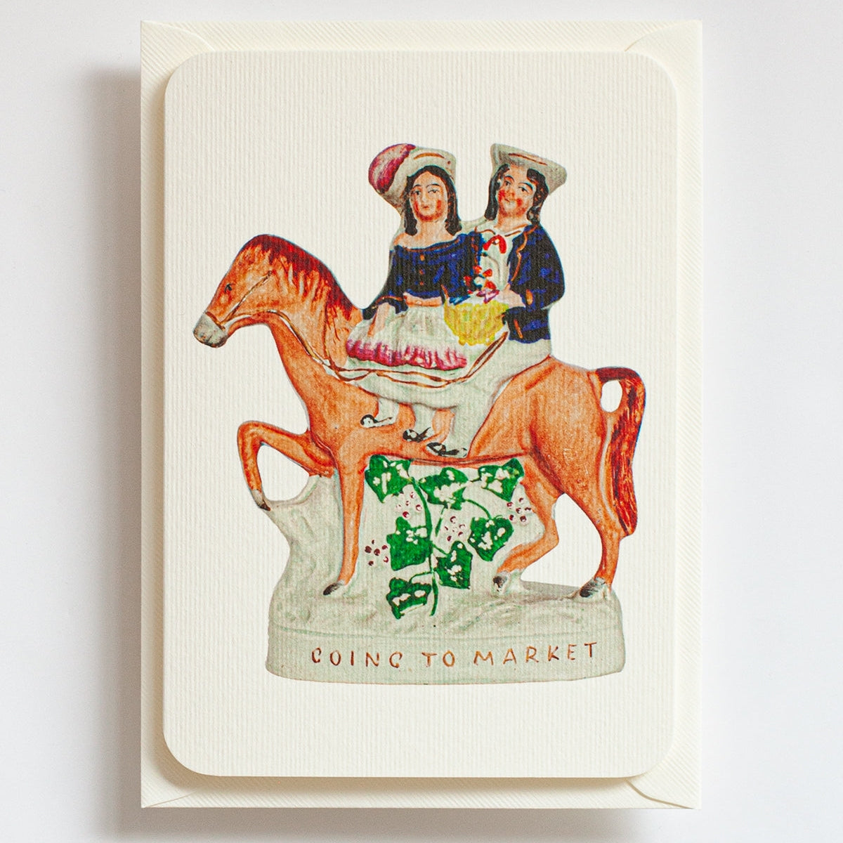Card with illustration of two people on a horse and text 'Going to Market' on a white background
