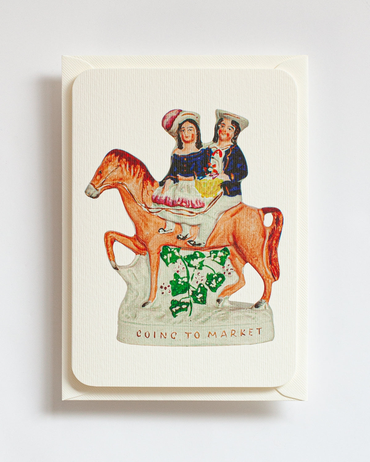 Card with illustration of two people on a horse and text 'Going to Market' on a white background