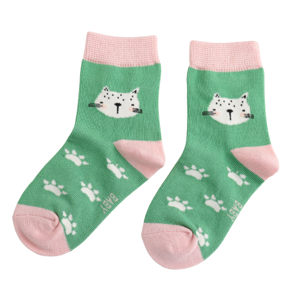 A pair of green baby socks with pink heels, toes, and cuffs, featuring a white cat face and white paw prints on the sides.