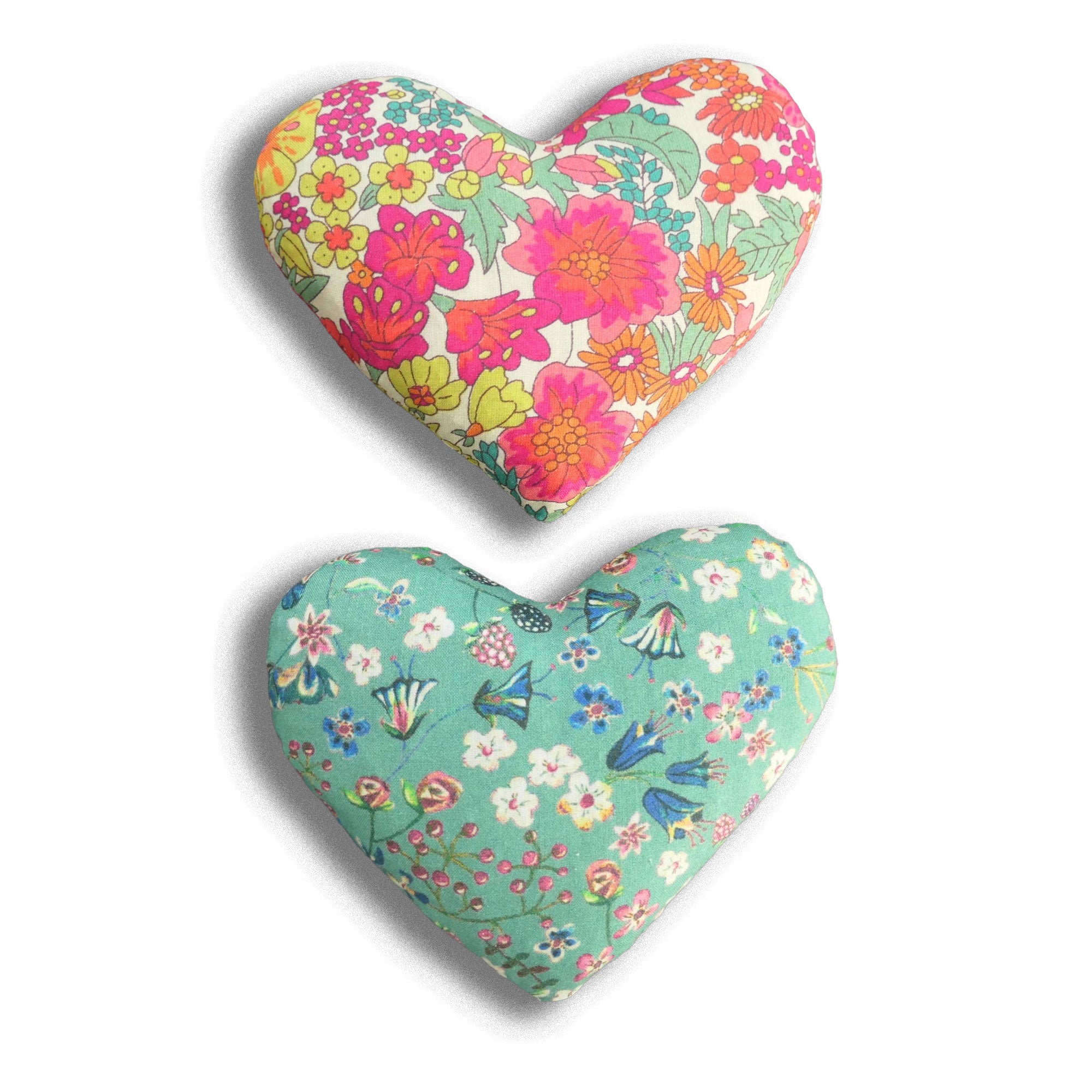 Two lavender hearts with green, red and yellow flowers on a white background
