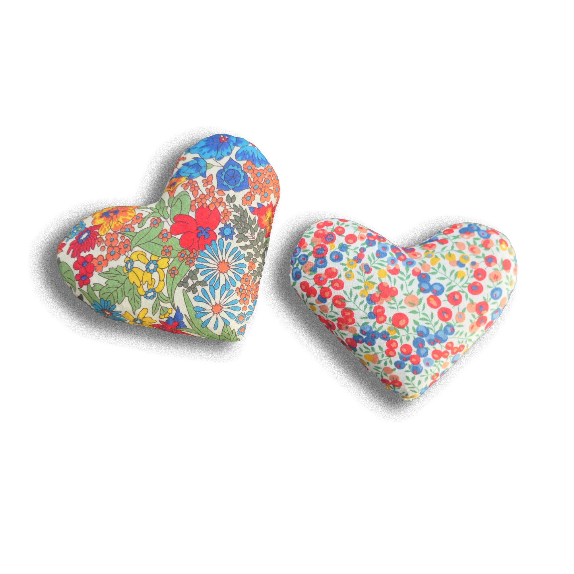 Two colourful heart-shaped lavender sachets on a white background