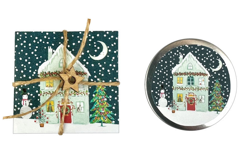Set of Christmas-themed items including a card and a round magnet with a house and tree design.