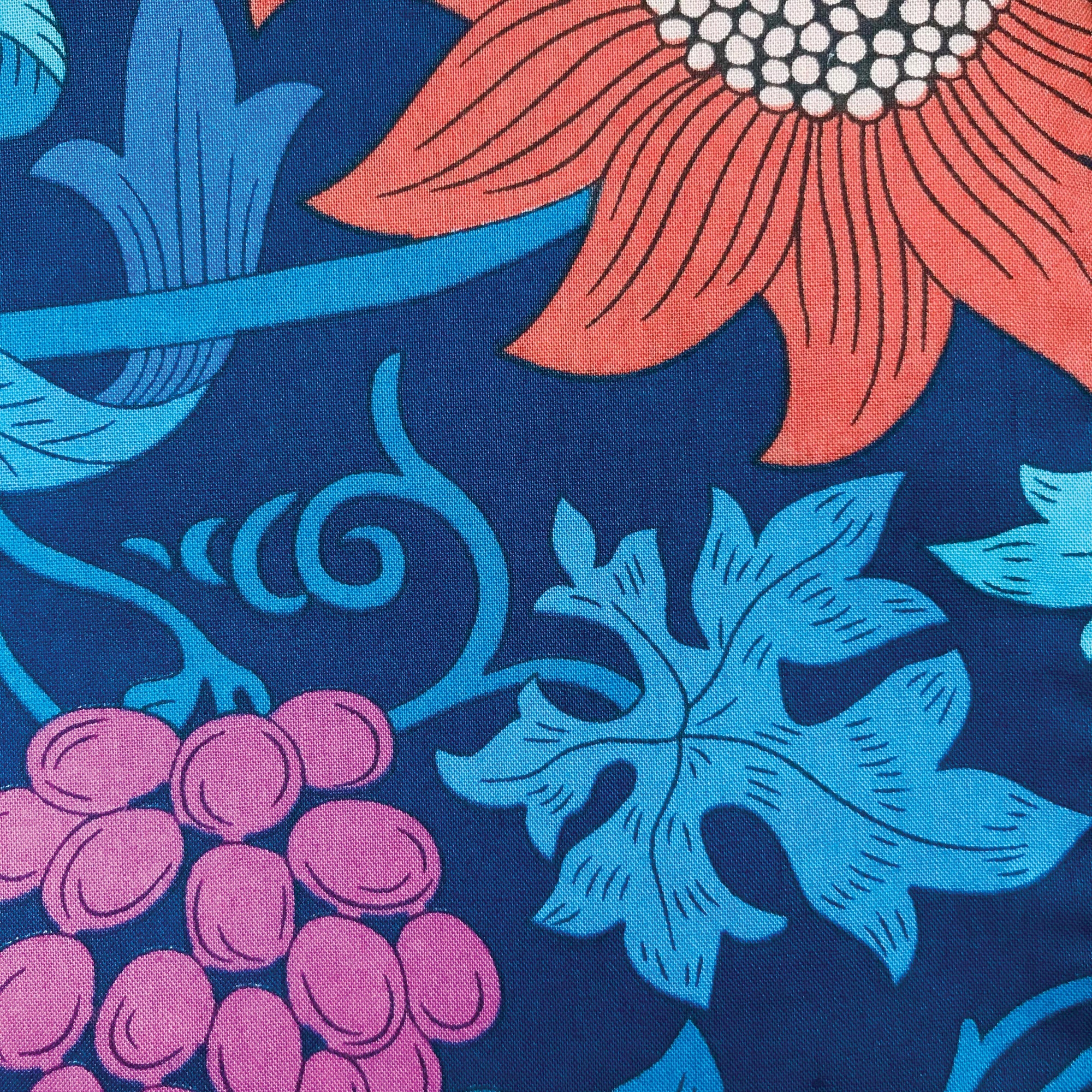 Floral and leaf pattern with pink flowers, blue leaves, and purple berries on a dark blue background.