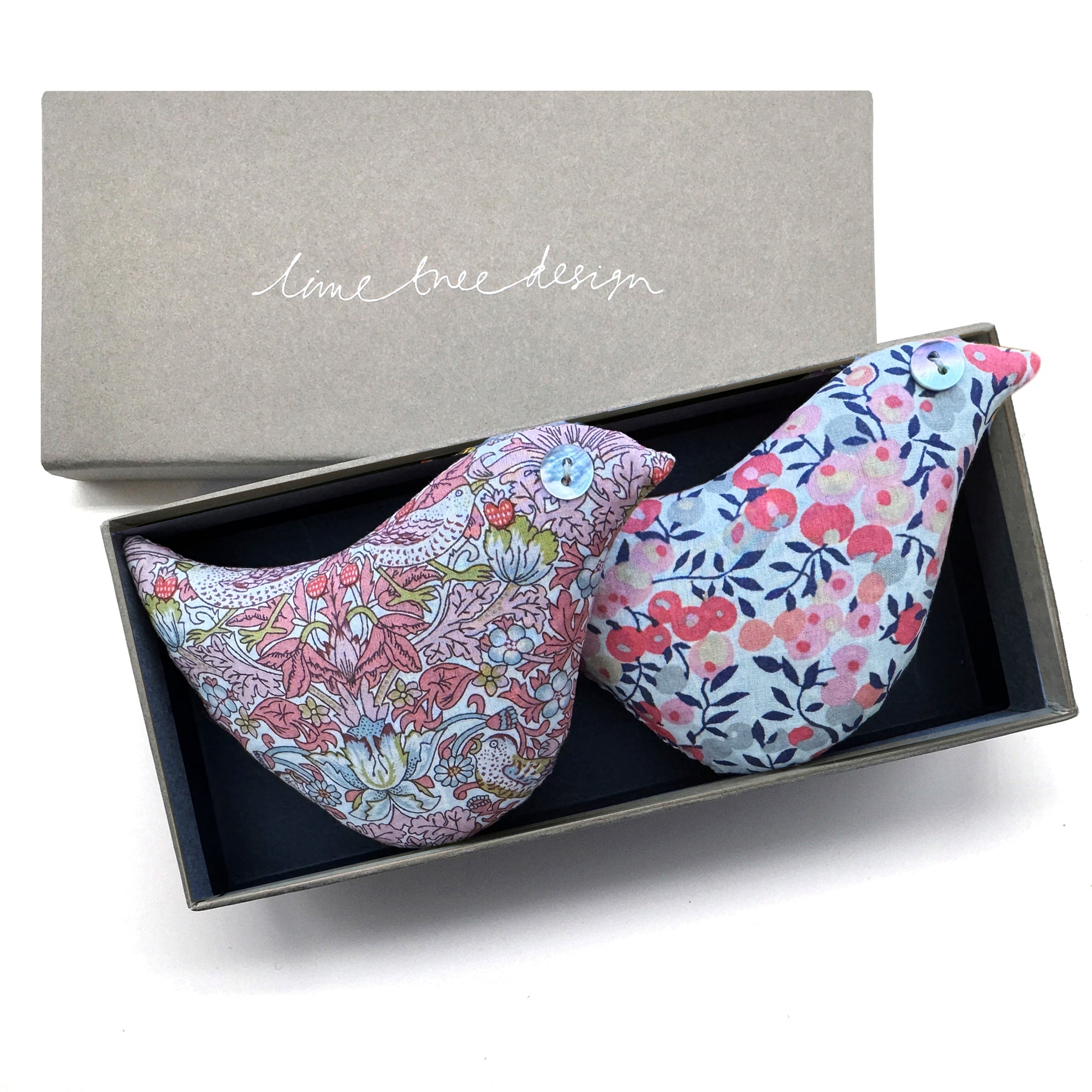 Two floral-patterned bird shaped lavender pillows in a box with 'lime tree design' branding.