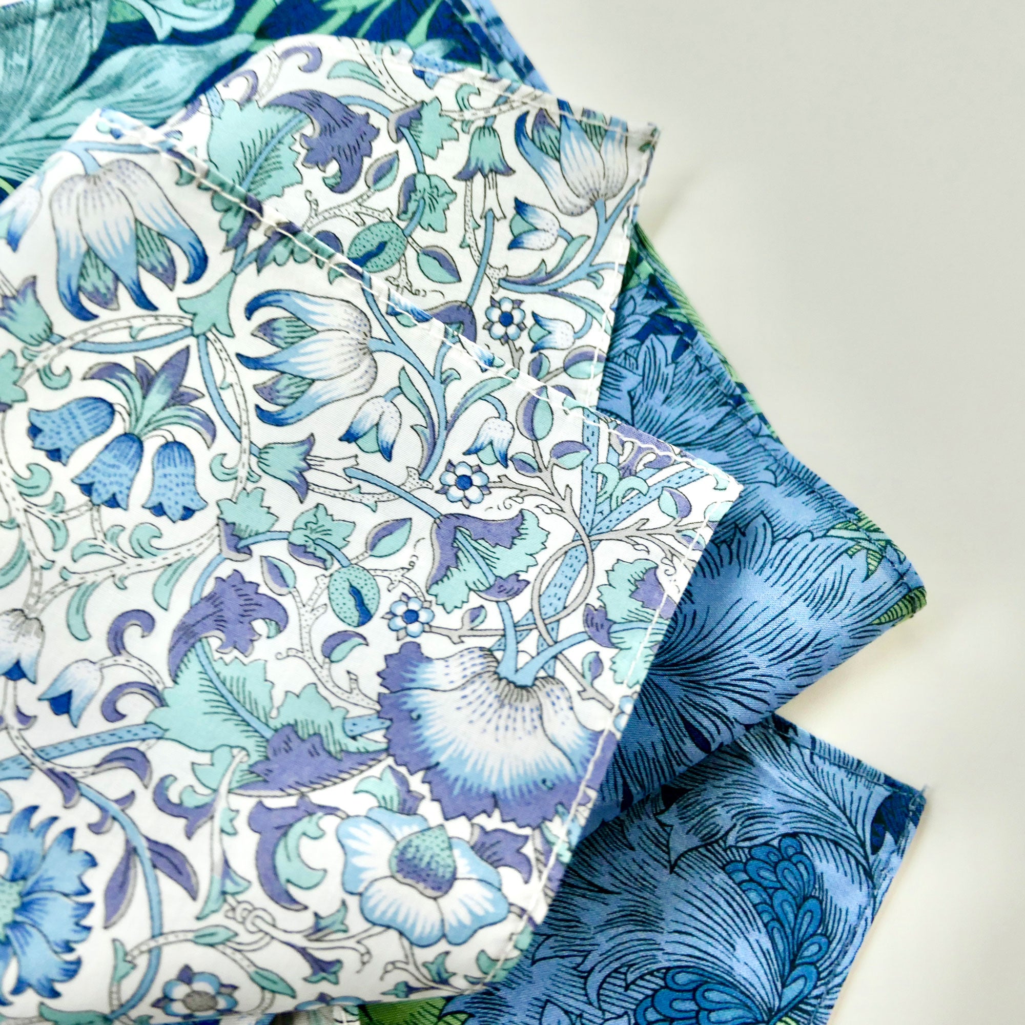 Floral patterned hanky with blue and green colours on a white background