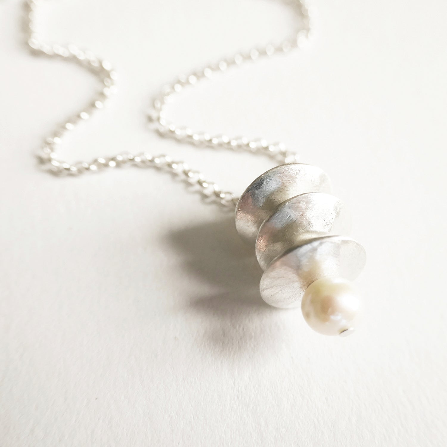 Necklace with a shell pendant on a light background