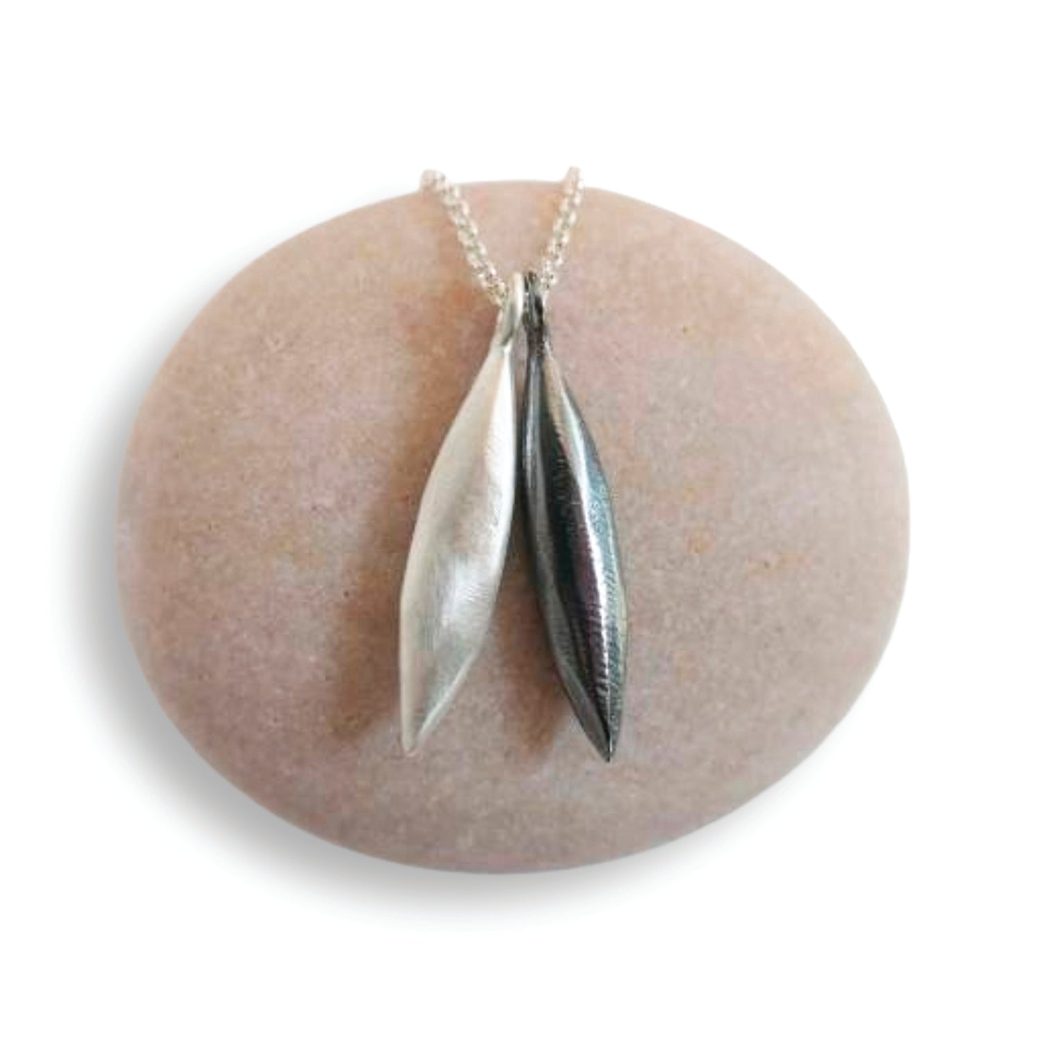 Silver pendant necklace on a stone surface