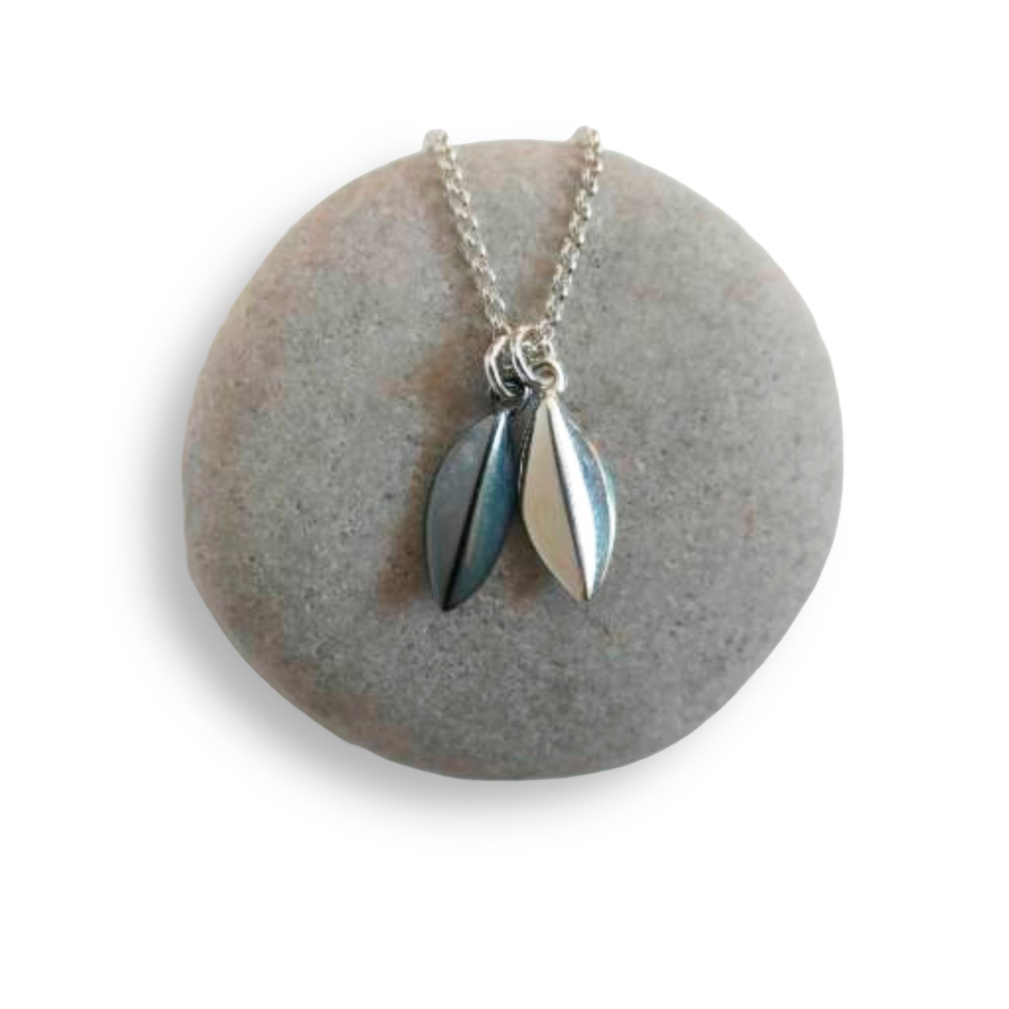 Silver seed pod necklace on a round stone