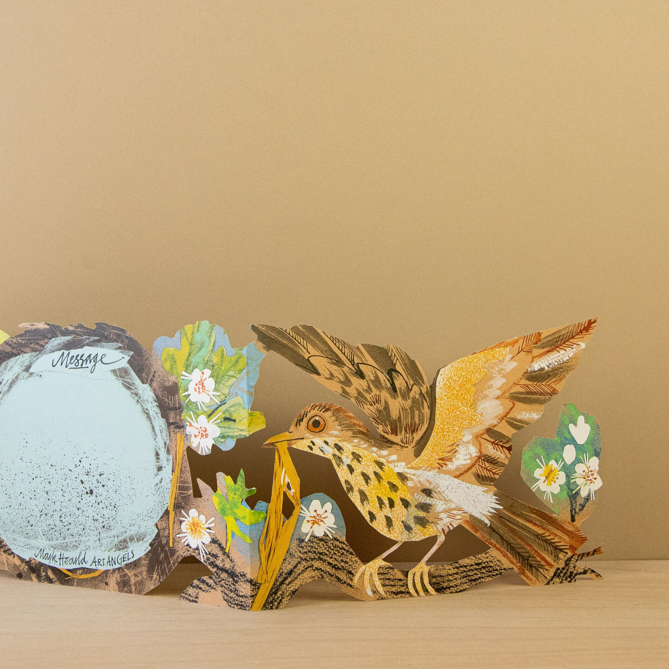 Concertina card featuring a bird with floral elements against a beige background