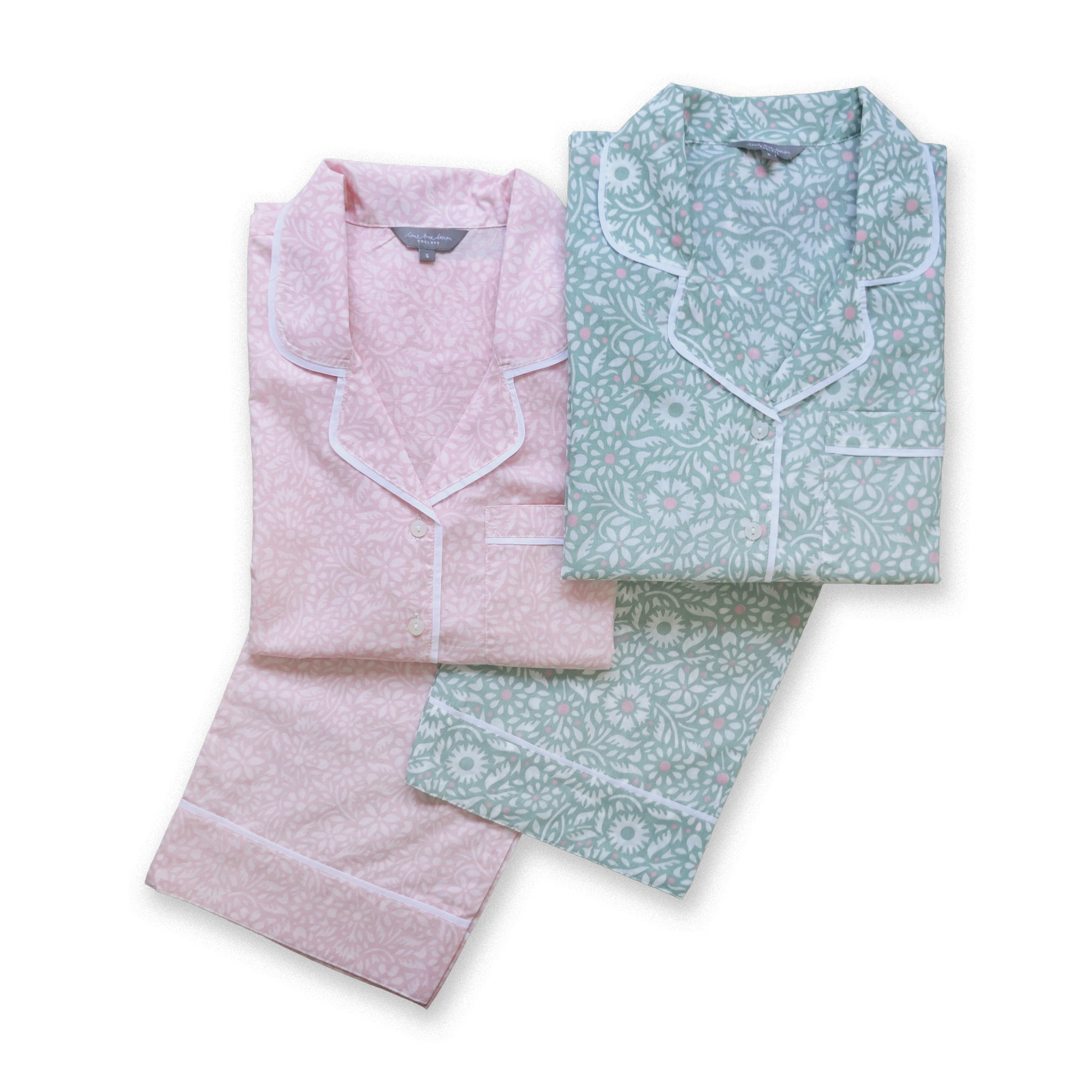 Two sets of patterned pajamas, one pink and one green, on a white background.