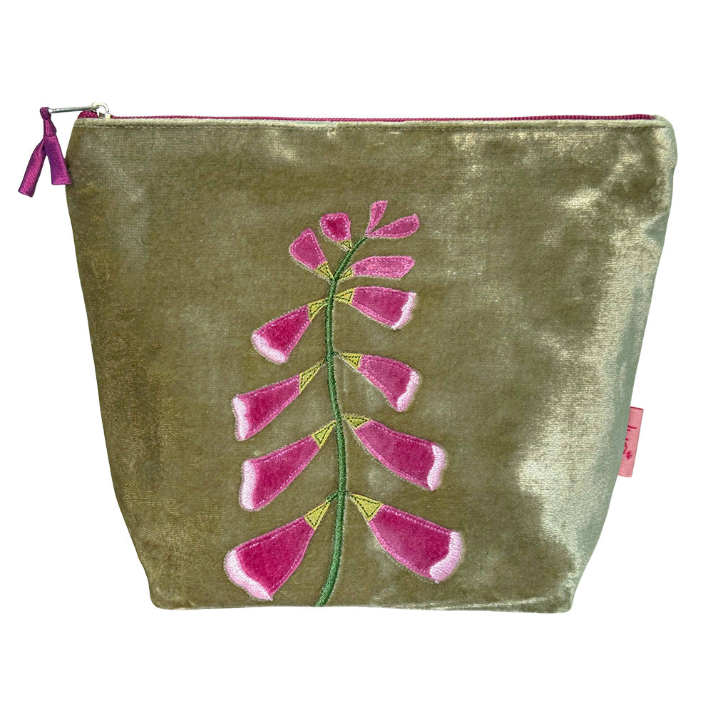 Velvet pouch with pink floral embroidery on a white background