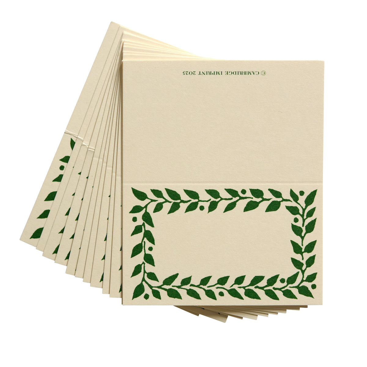 Beige paper with green leaf pattern on a white background
