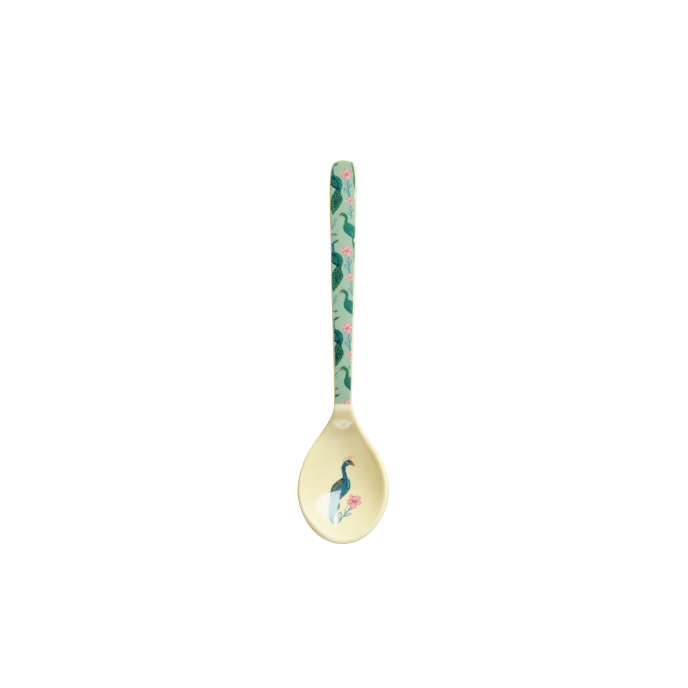 Decorative spoon with peacock design on a white background