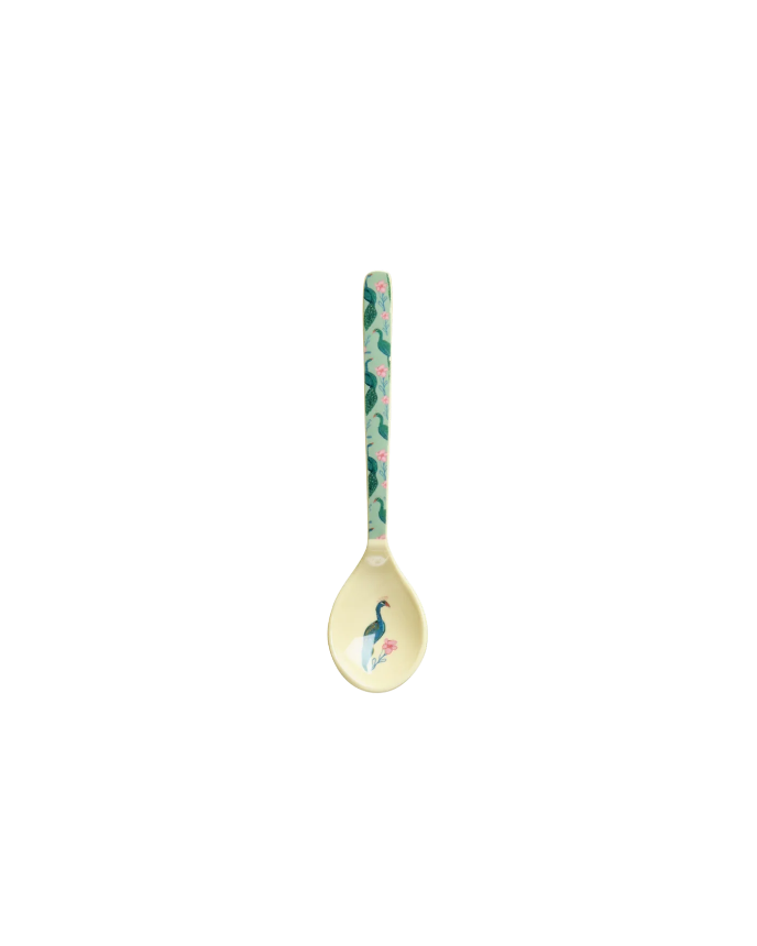 Decorative spoon with peacock design on a white background