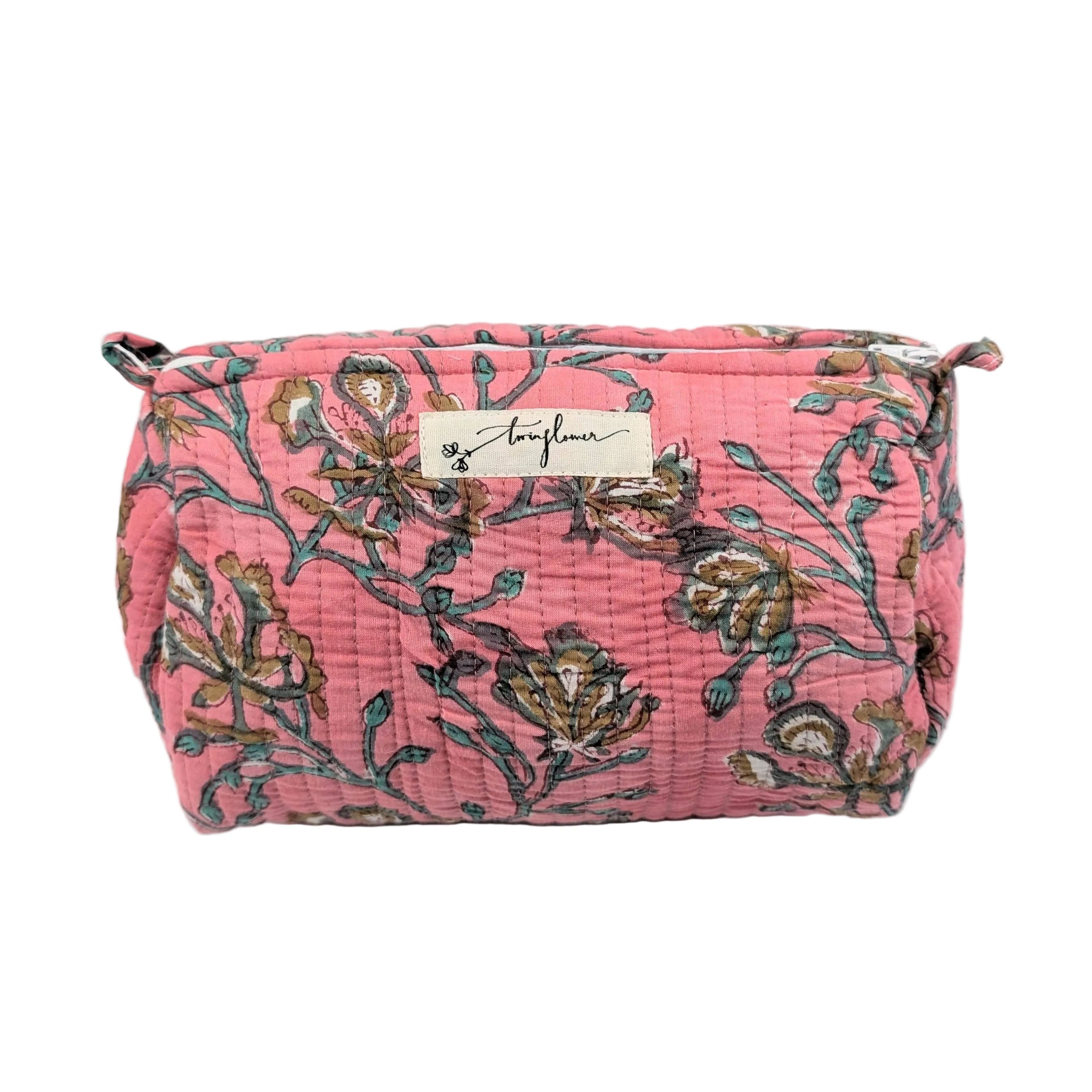 Floral patterned makeup bag with a brand label on a white background