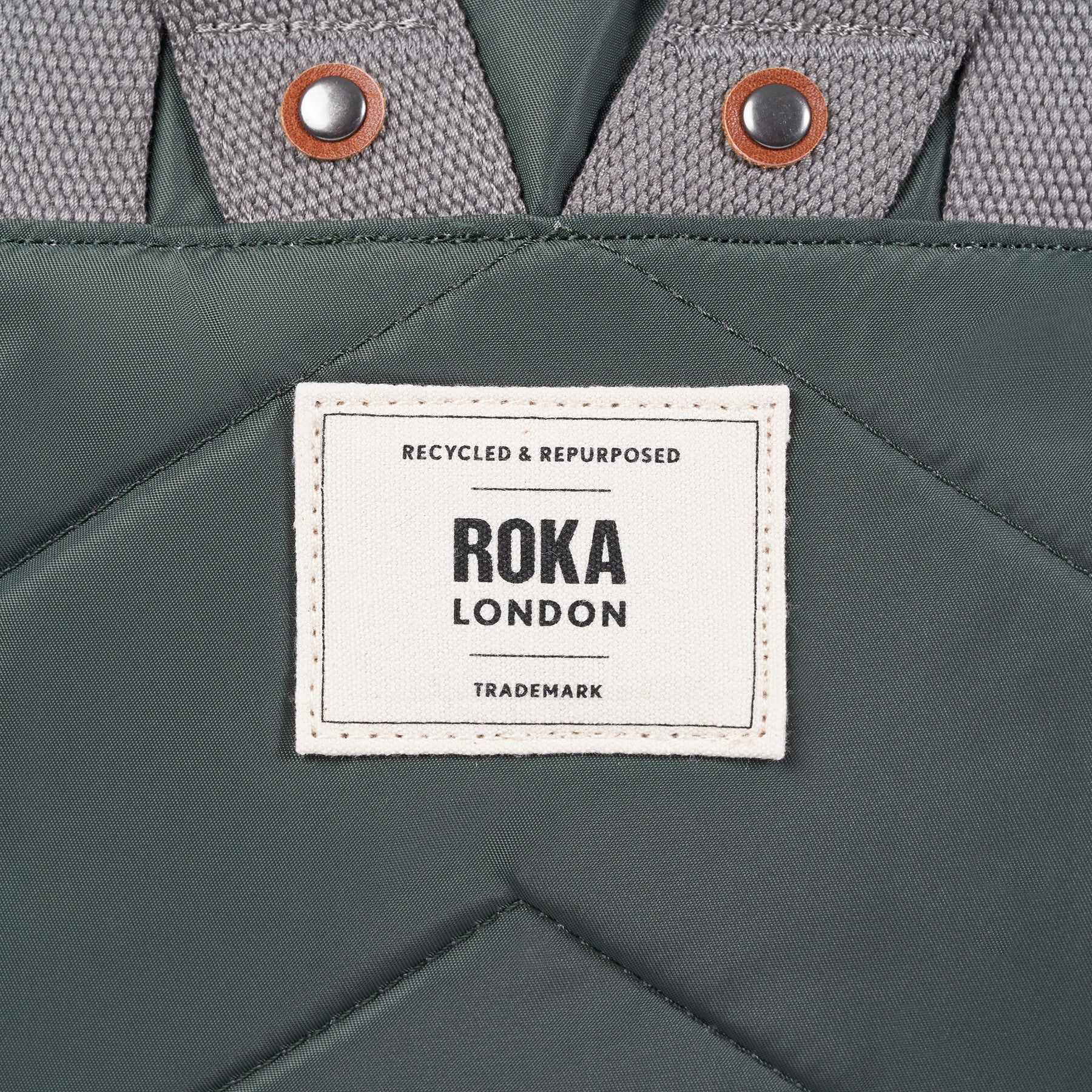 Gray fabric with a Roka London label on a gray background