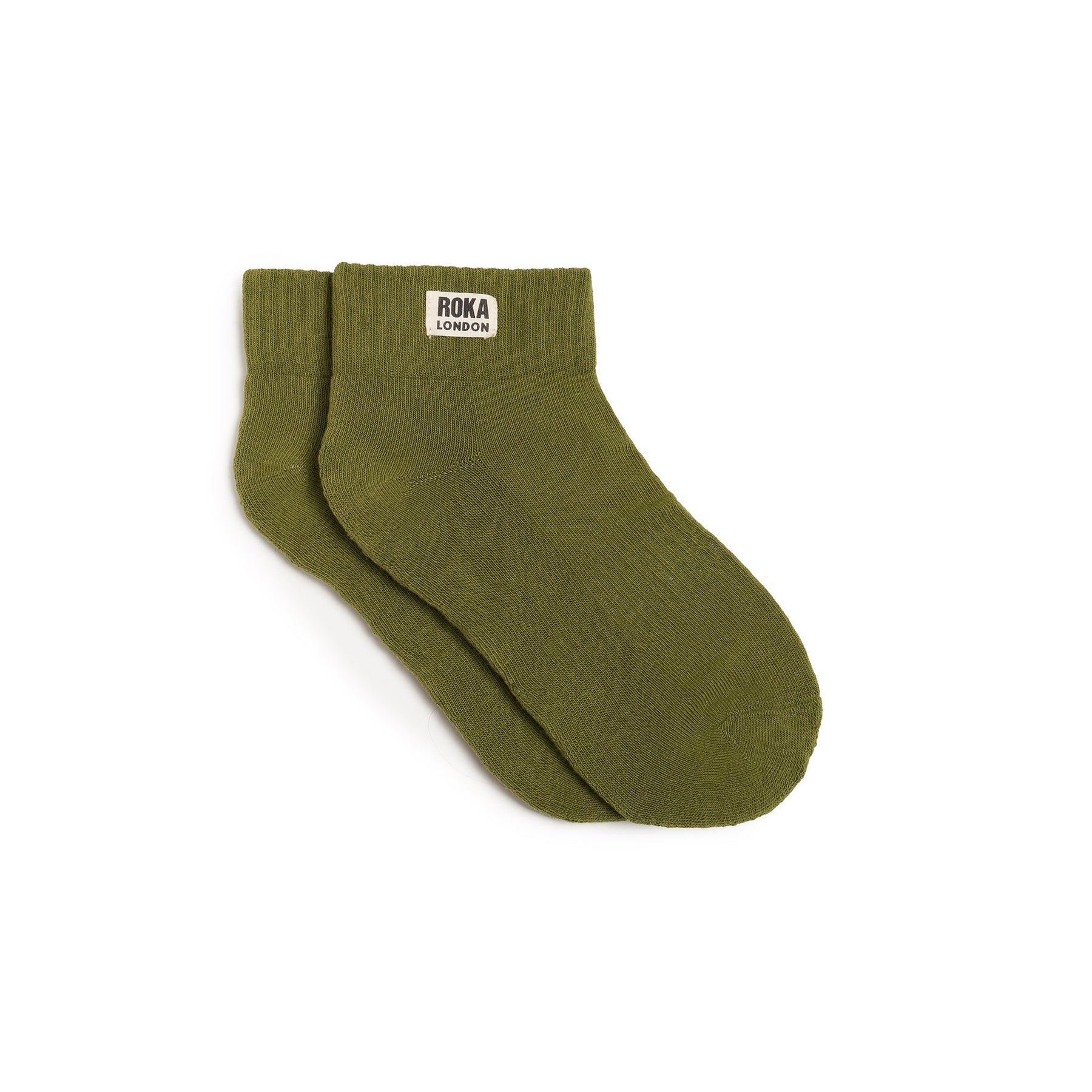 Green sock with a visible brand label on a white background