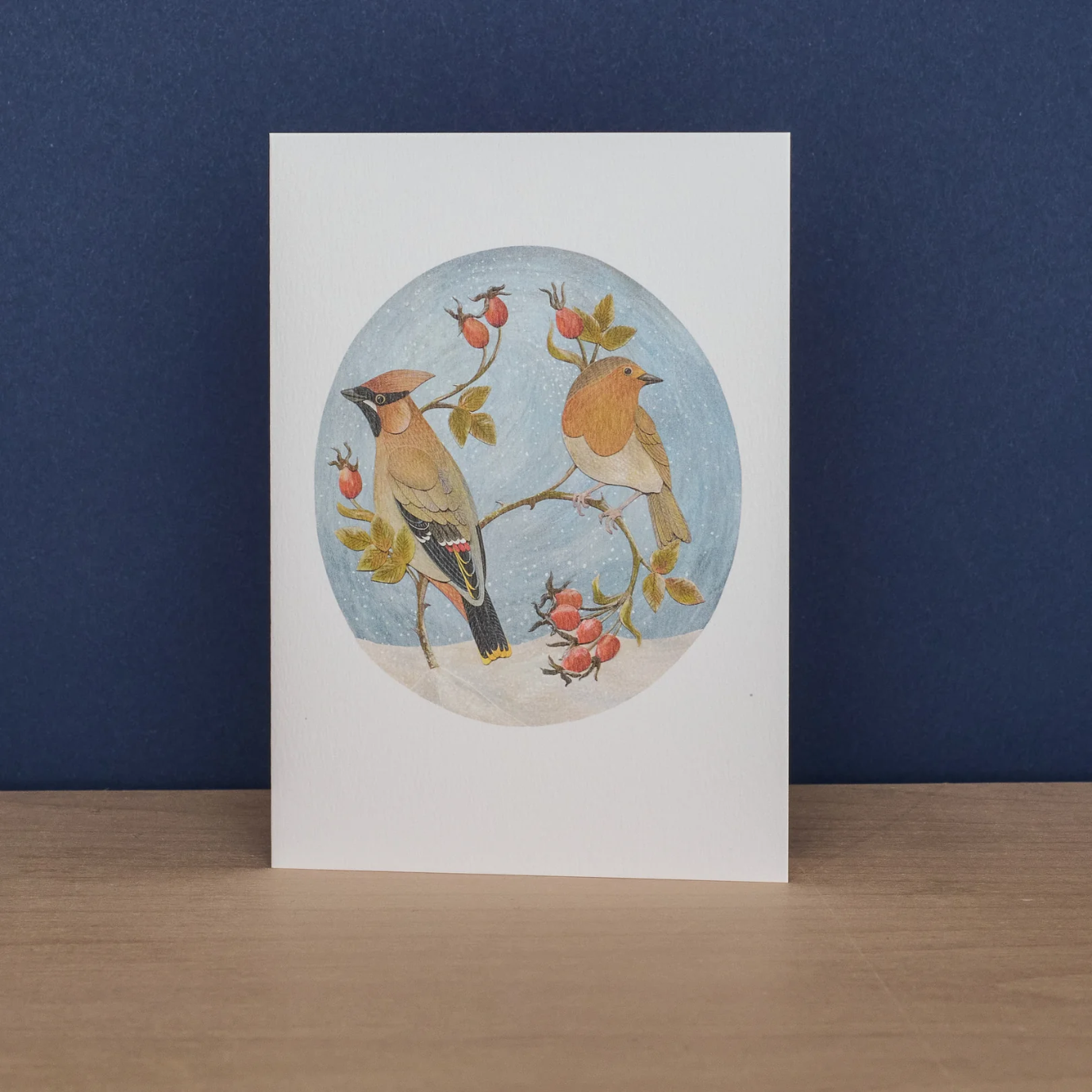 Card with bird illustration on a white background against a blue wall