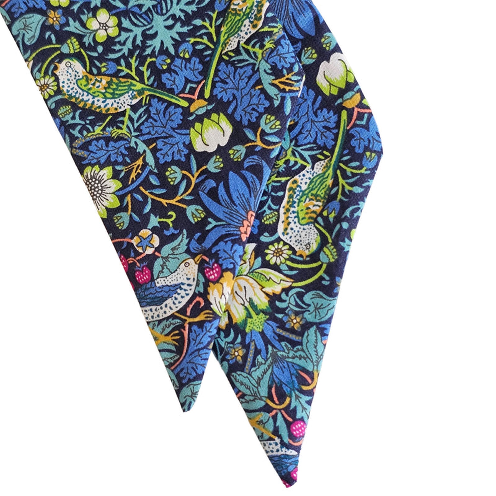 Floral and bird patterned scarf on a white background