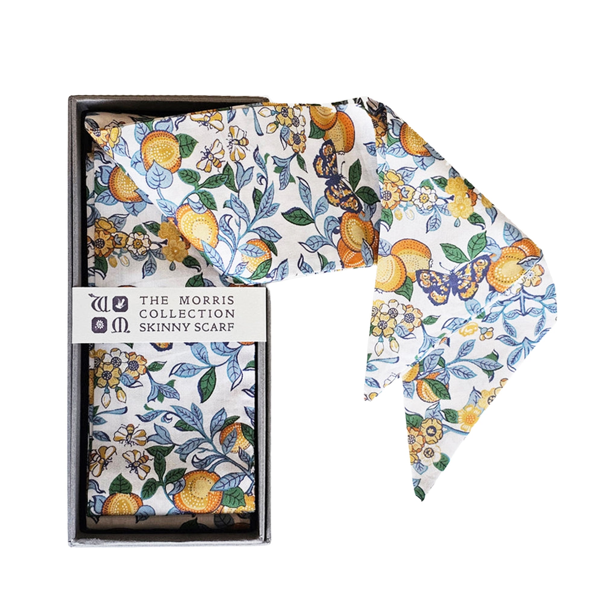 Skinny scarf with floral and fruit pattern in a box on a light background