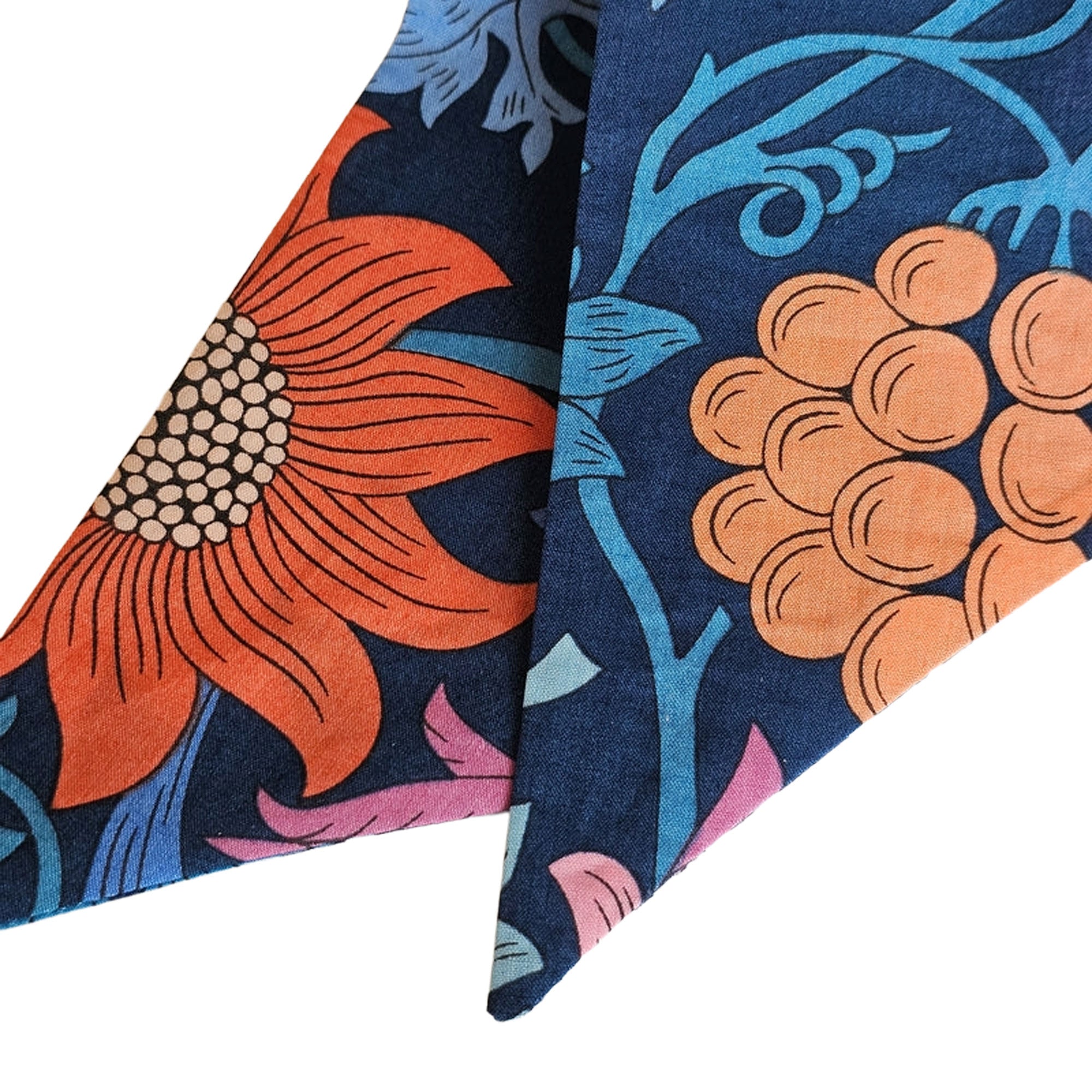 Floral patterned fabric scarf with orange and blue design on a light background
