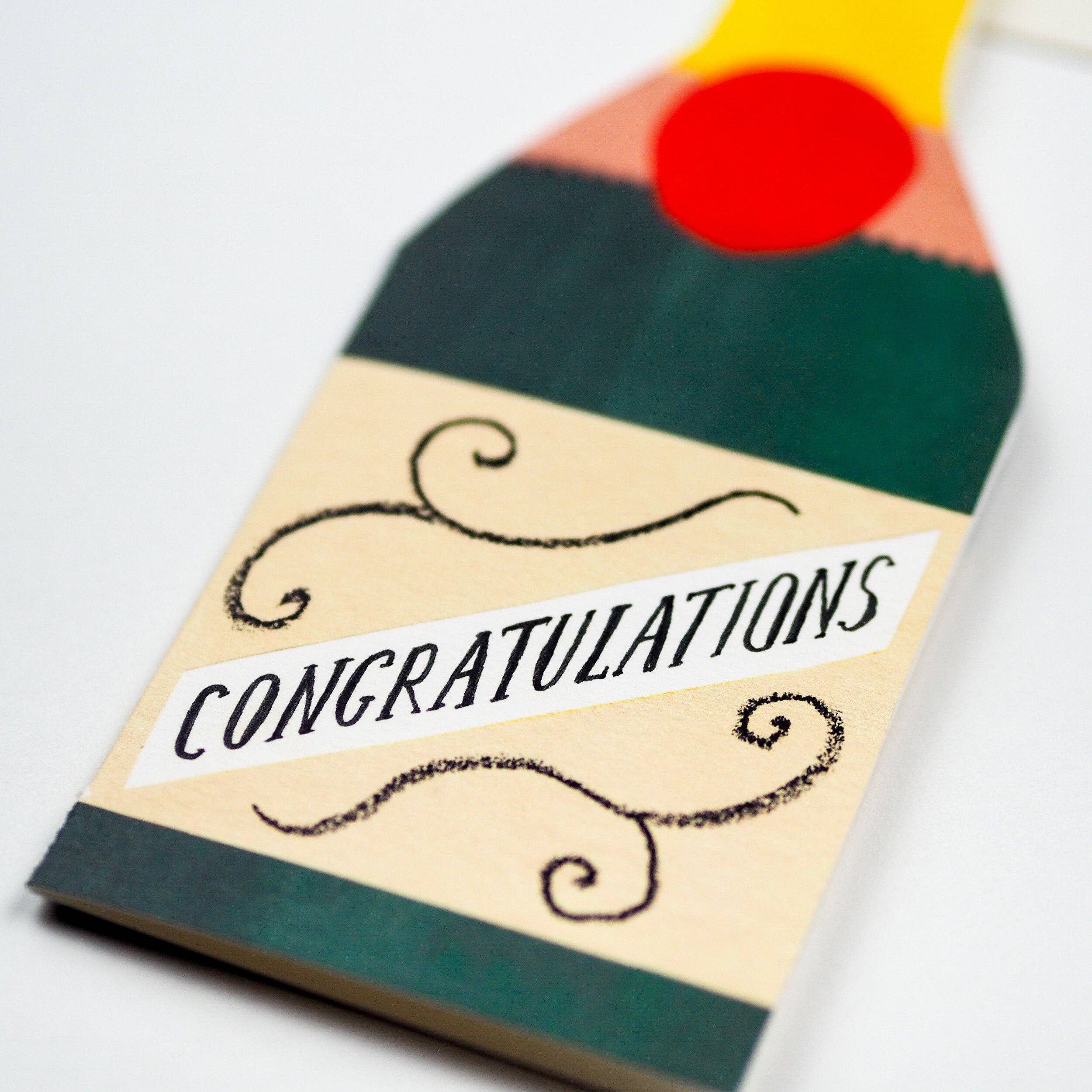 Colorful matchbox with 'Congratulations' text on a white background