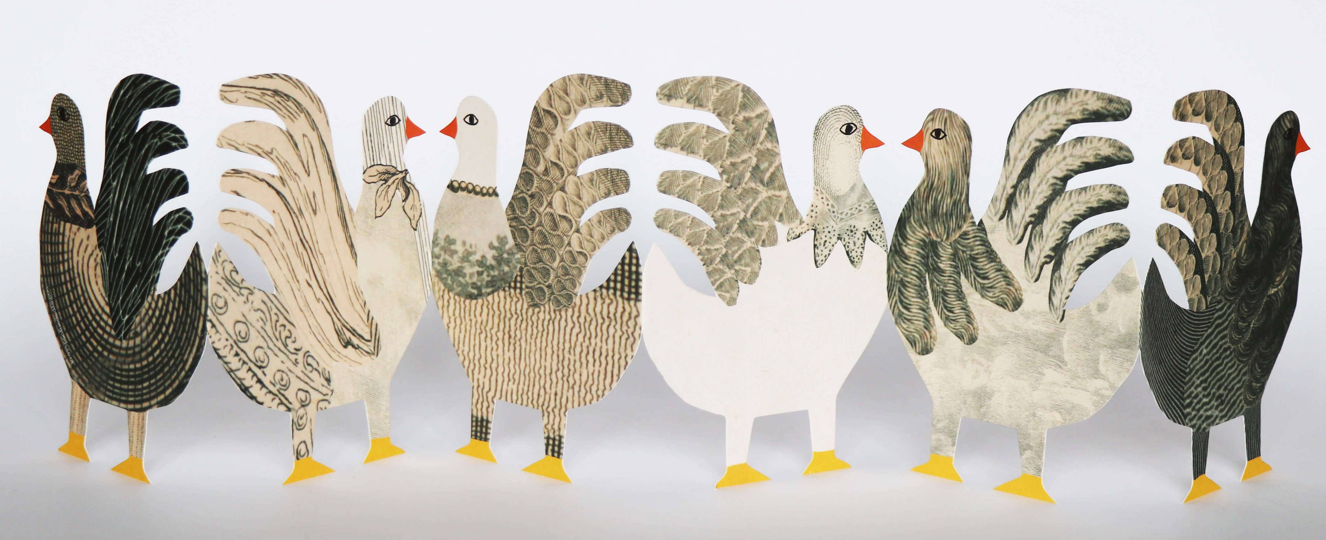 Row of stylized rooster figurines in various colors on a white background