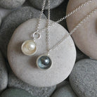 Necklace with pendant on pebbles