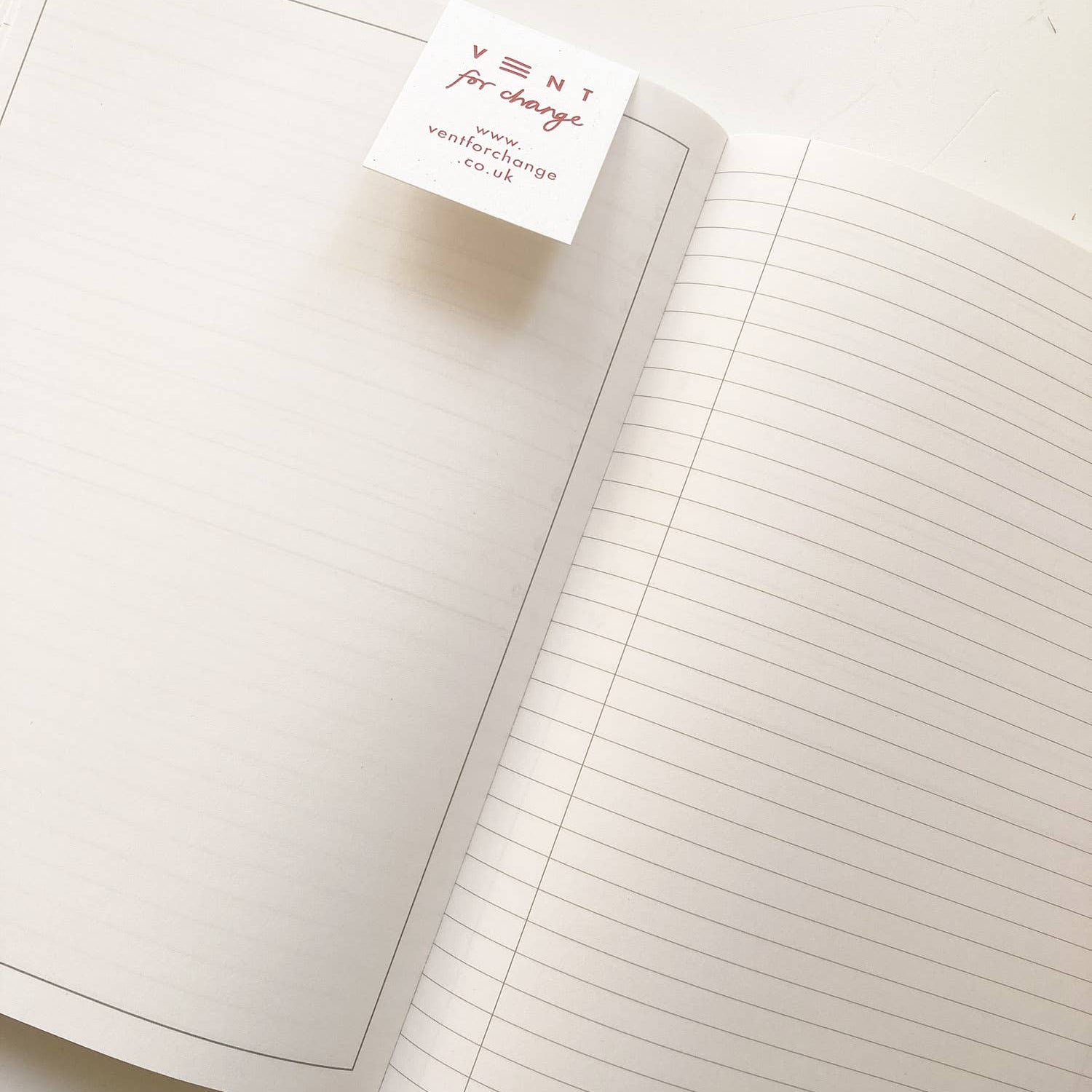 Open notebook with lined pages and a visible brand label on a white background