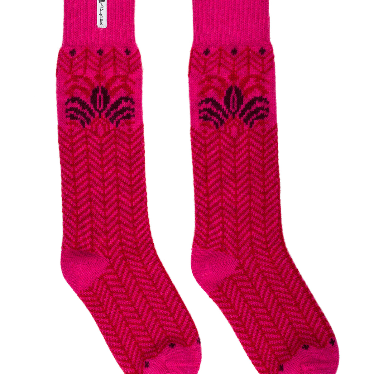 A pair of bright pink crew socks with a dark pink herringbone knit pattern and a small white brand tag near the cuff, displayed against a plain white background.