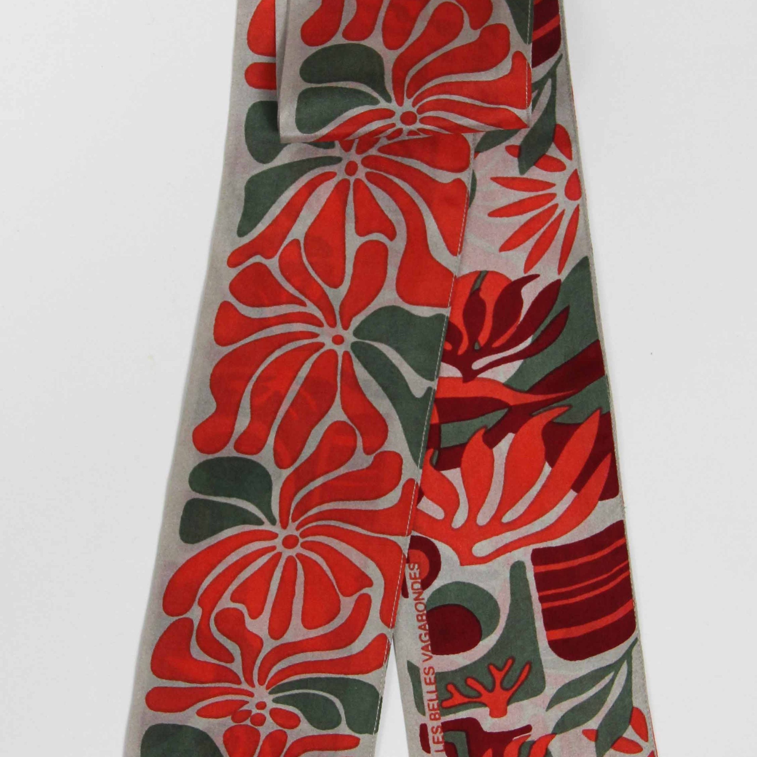 Floral patterned tie with red and green design on a white background