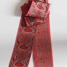 Red patterned pants with a matching top on a white background