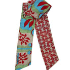 Colorful patterned scarf with red, blue, and green design on a white background