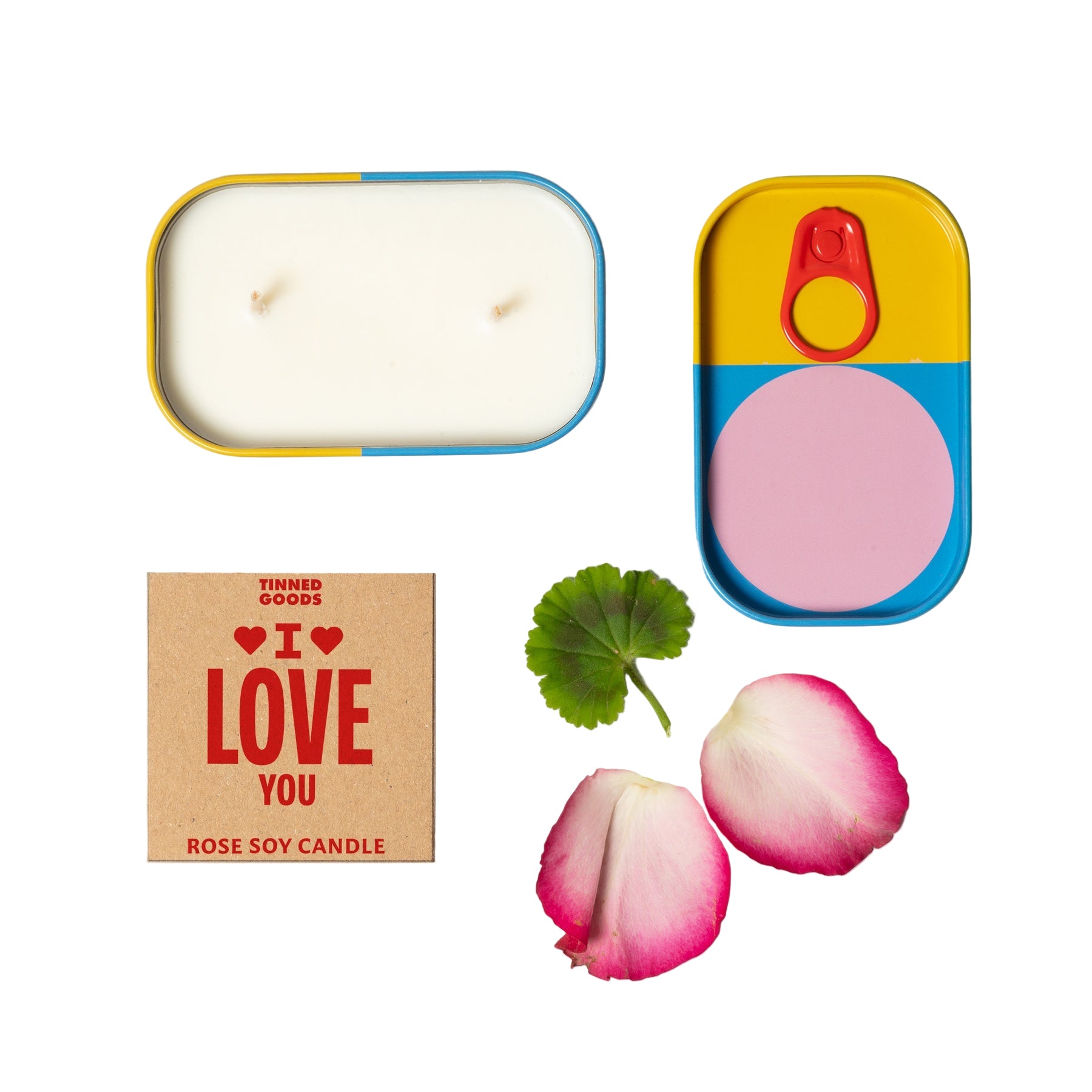 Candle in a tin with a decorative box labeled 'I LOVE YOU' and rose petals on a light gray background.