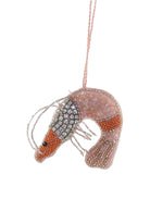 Decorative shrimp ornament with beaded details on a white background