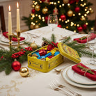 Yellow tin box with colorful candies and decorative lid on a white background